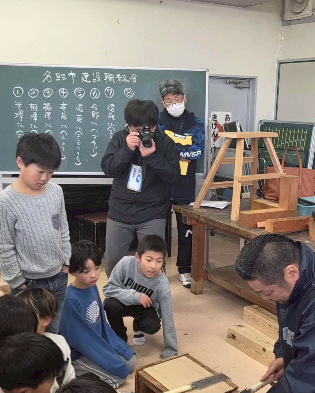 子どもたちが職人の説明に耳を傾けます。